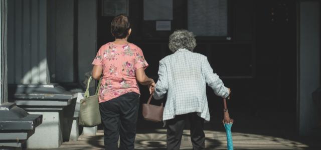 man in white and blue checked dress shirt standing beside woman in pink shirt by Jomarc Nicolai Cala courtesy of Unsplash.