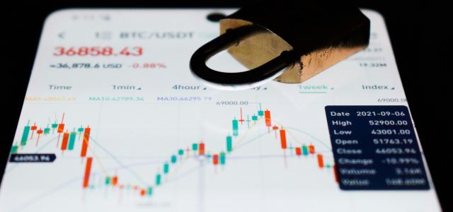 a close up of a business card with a stock chart on it by lonely blue courtesy of Unsplash.